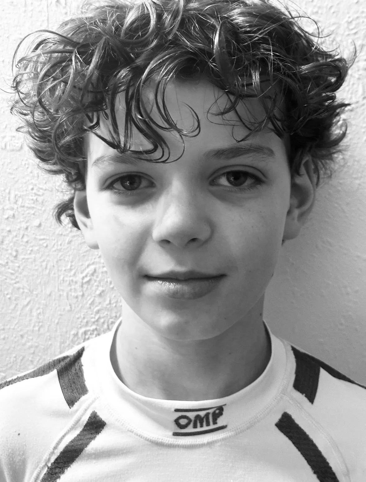 Ryan Rijvers photographed head-on in black and white, in a racing
underlayer, against a plain wall.
